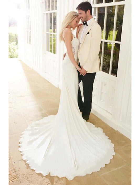 Elegant mermaid V-neck wedding dress with lace appliques.