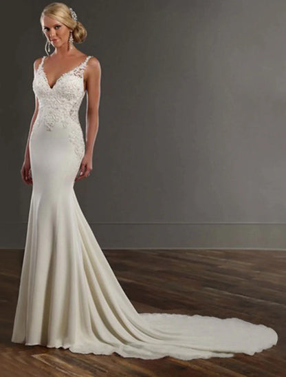 Close-up of lace appliques on a V-neck wedding dress.