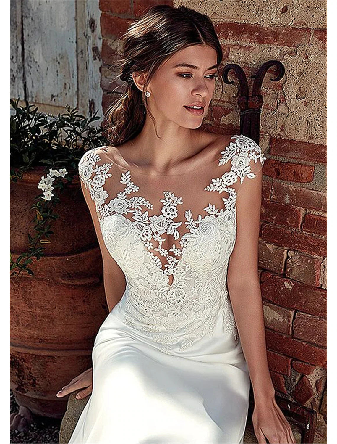 Side view of the bride in the elegant chiffon mermaid wedding gown.