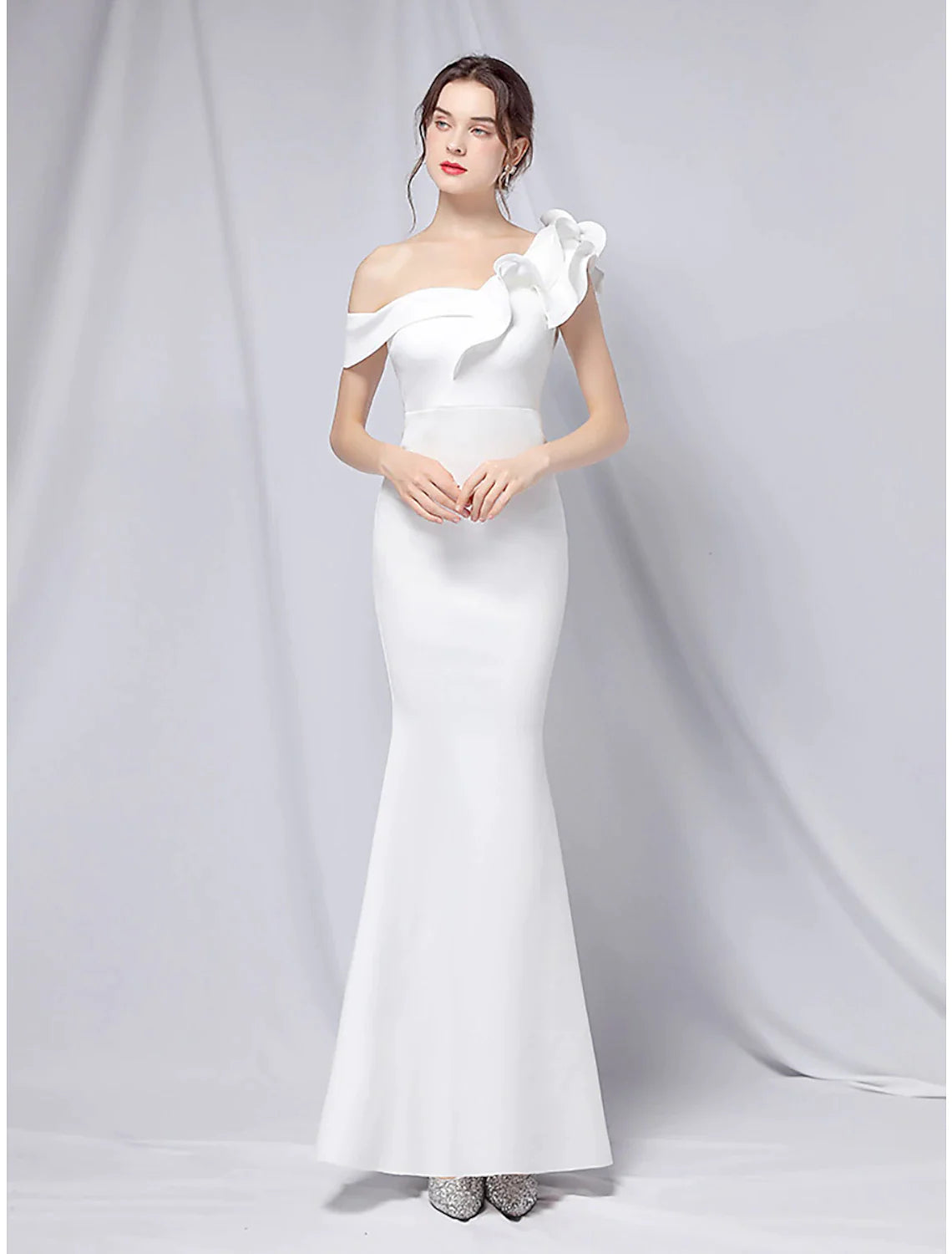 Elegant one-shoulder mermaid trumpet evening gown with ruffles.