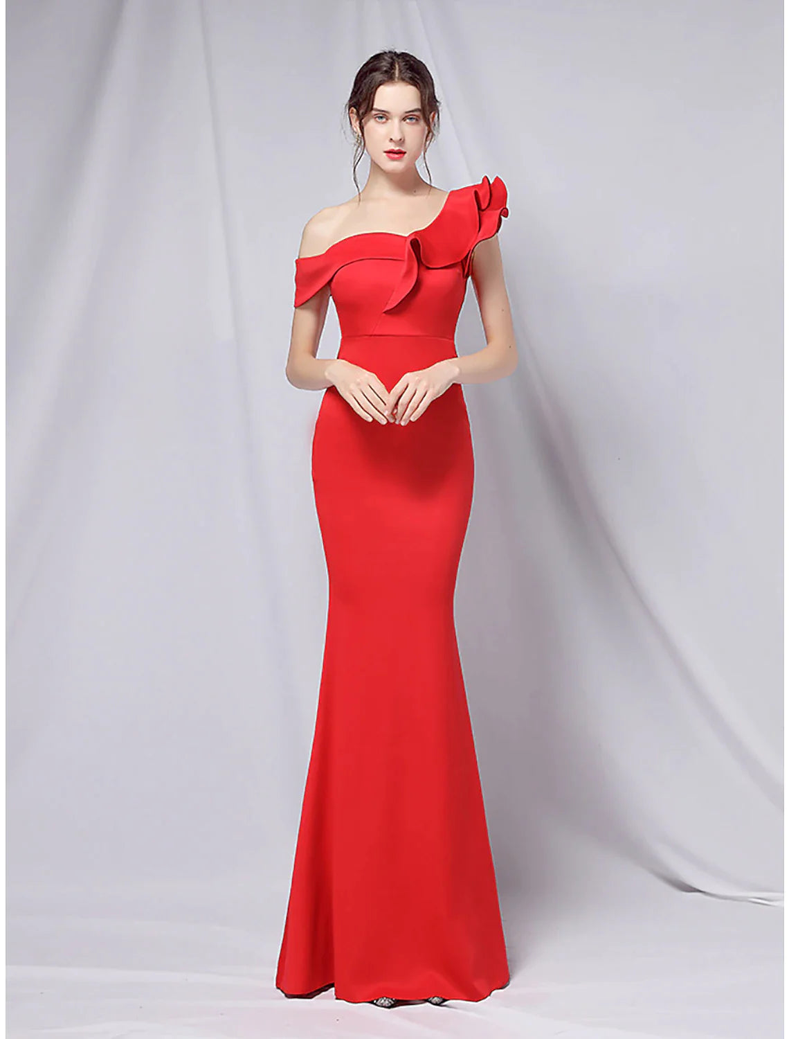 Close-up of the one-shoulder neckline and ruffled detail on the gown.