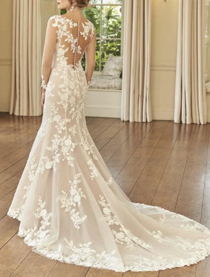 Close-up of the back of the lace wedding dress, showing court train and intricate embroidery.