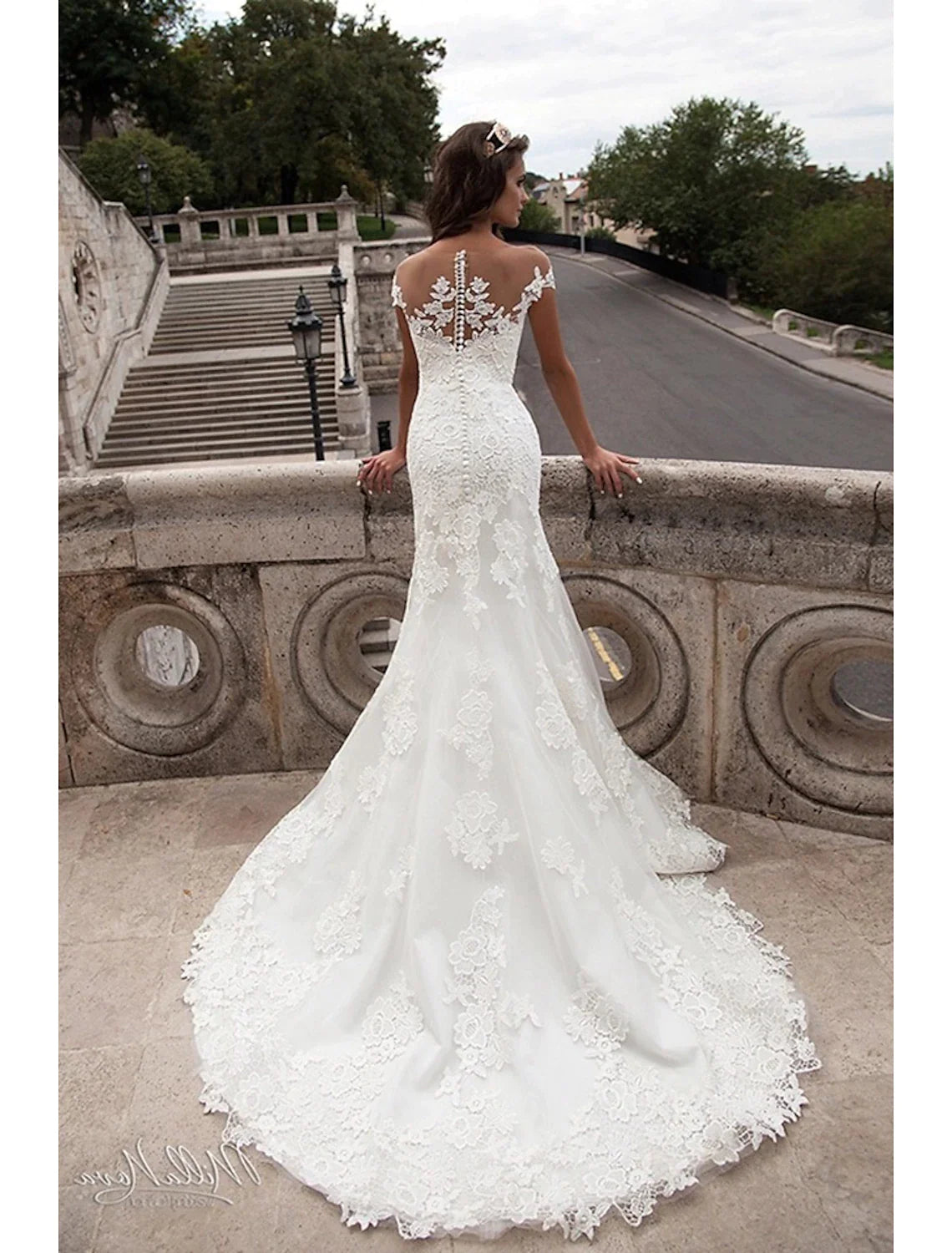 Back view of the mermaid wedding dress, highlighting the open back and court train.