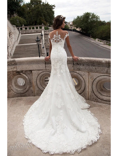 Back view of the mermaid wedding dress, highlighting the open back and court train.