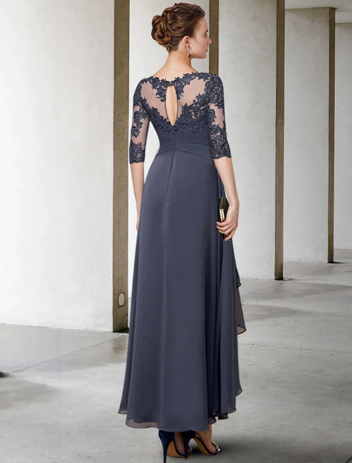 Back view of an elegant plus size A-line chiffon lace dress with ruched appliques.