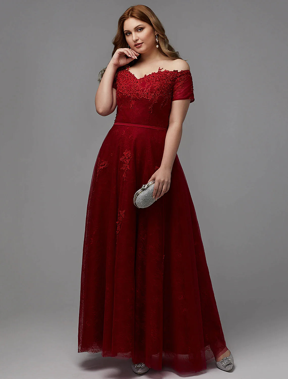 Back view of a plus size A-line dress showing lace-up closure and floor-length skirt.
