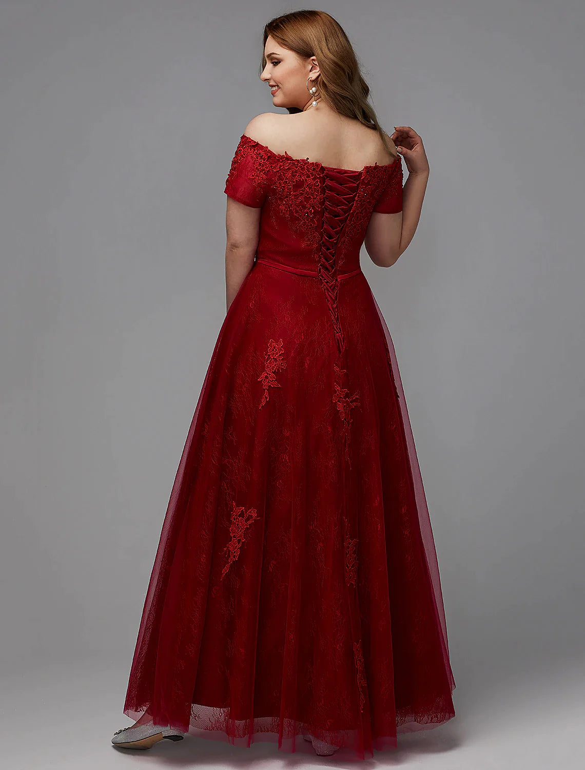 Side profile of an elegant plus size off-shoulder short sleeve dress.