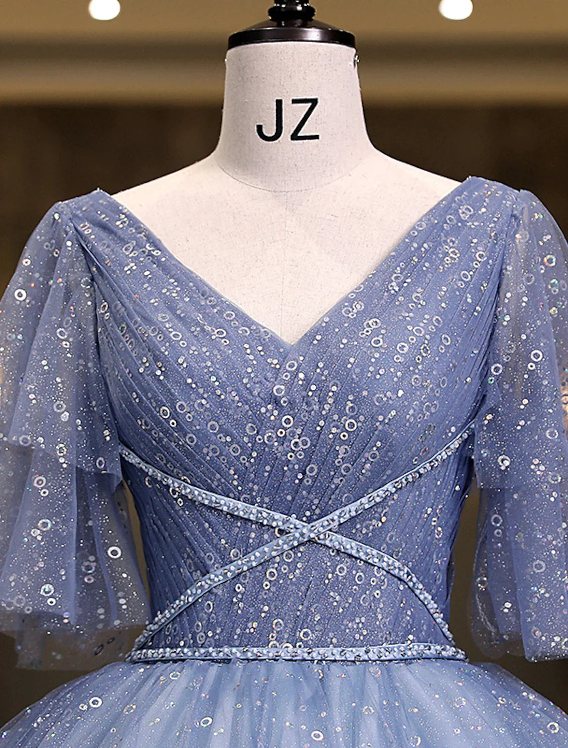 Close-up of the sequin bodice and V-neckline of the princess Quinceanera dress.
