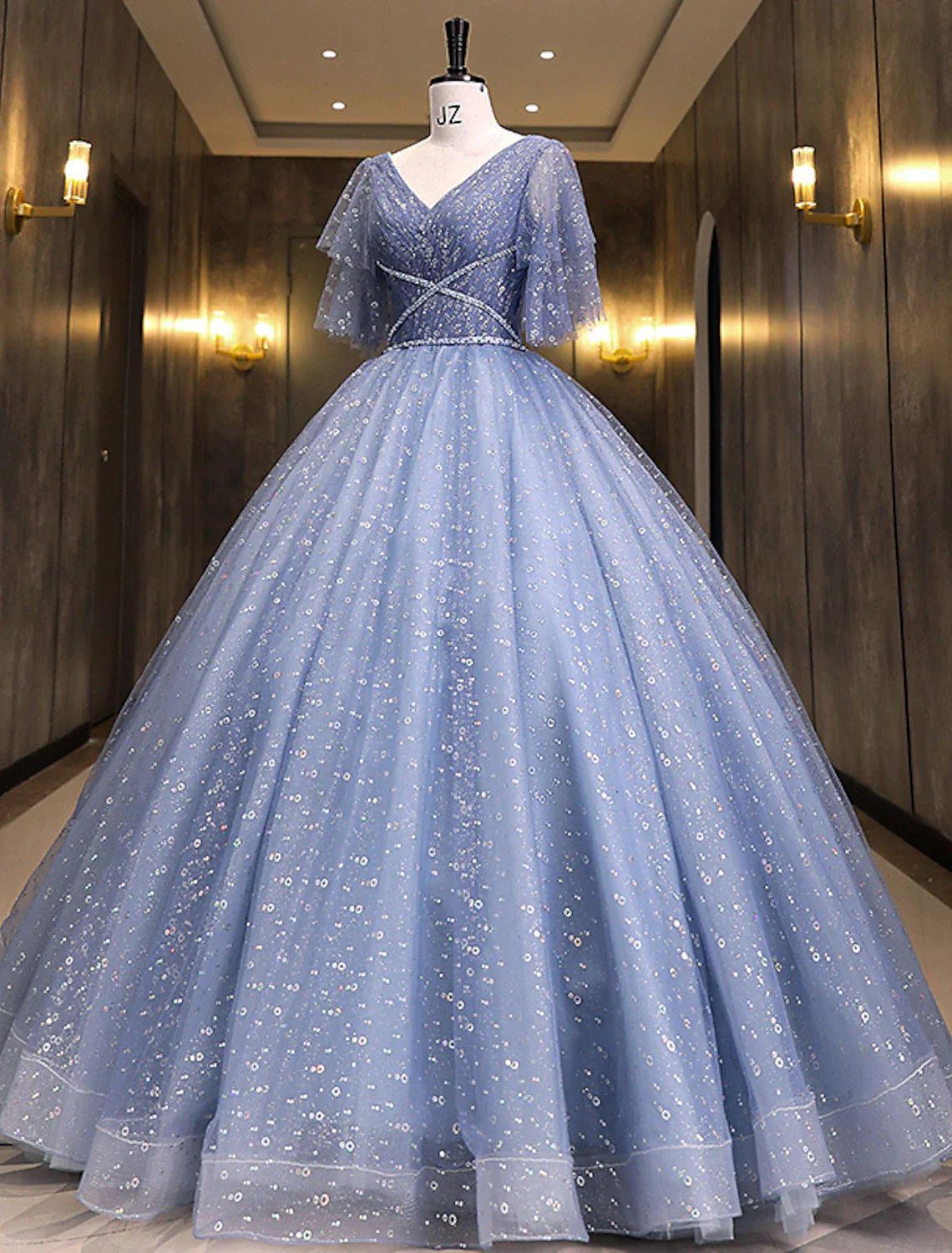 Side view of the elegant short sleeve sequin ball gown Quinceanera dress.