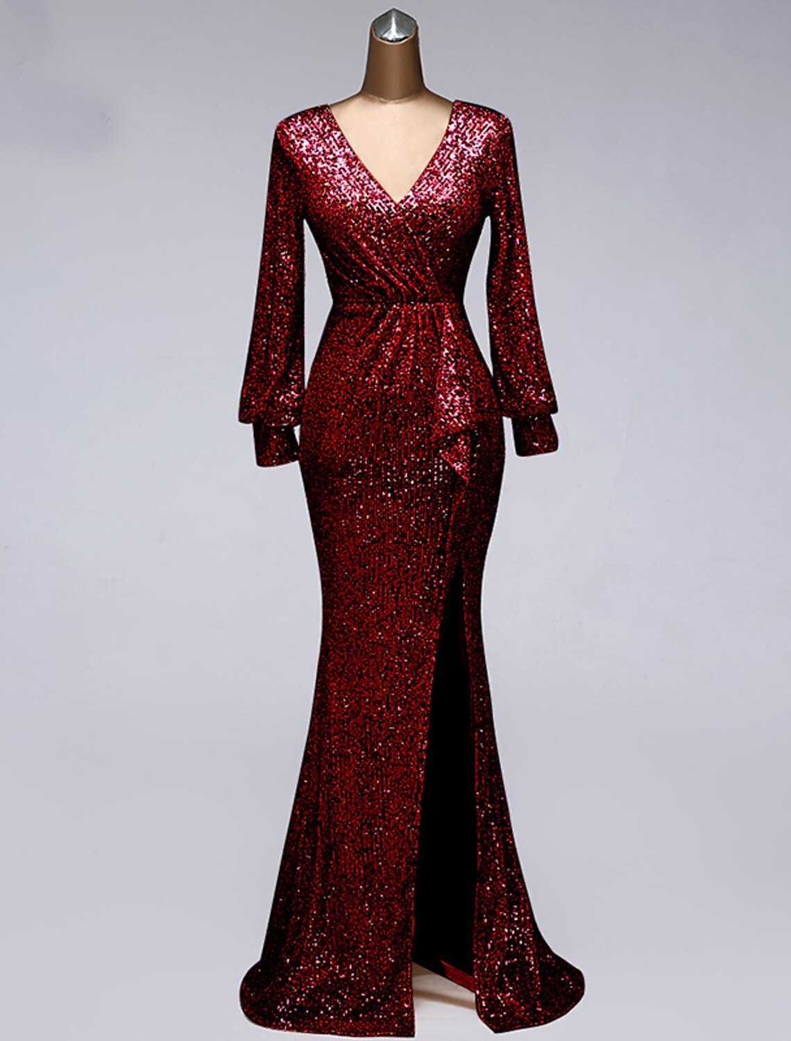 Model posing in a floor-length sequin mermaid trumpet evening dress.
