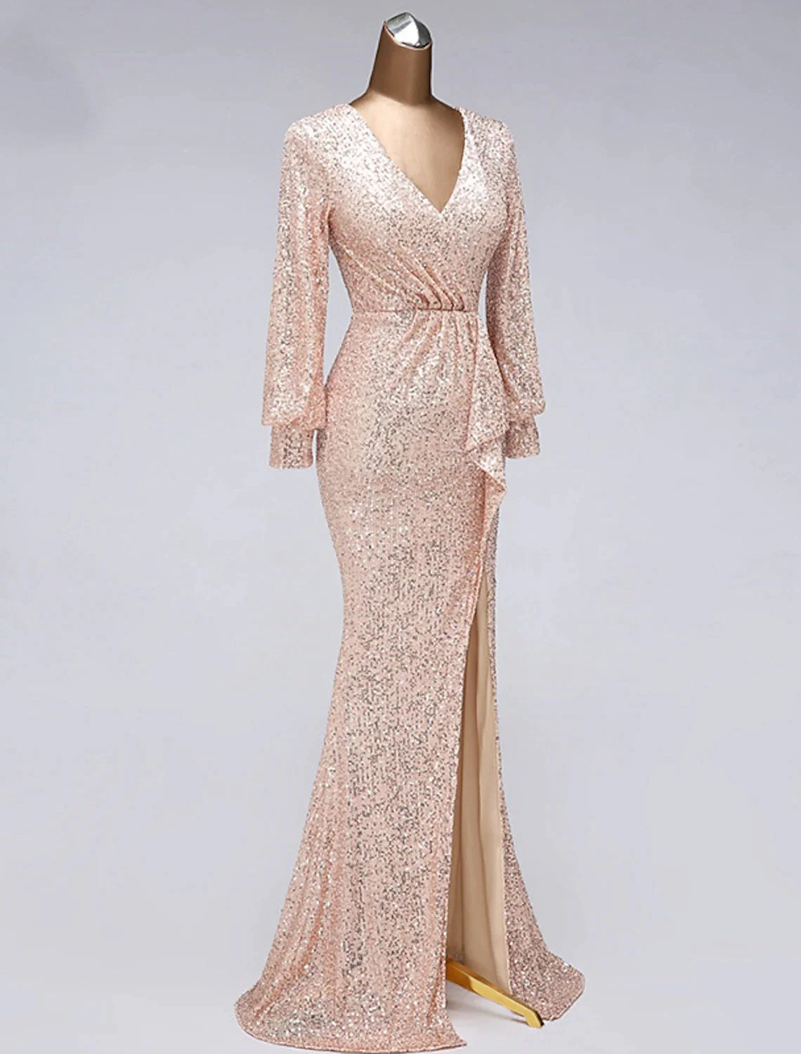 Side view of the V-neck sequin tulle mermaid trumpet gown with a slit.