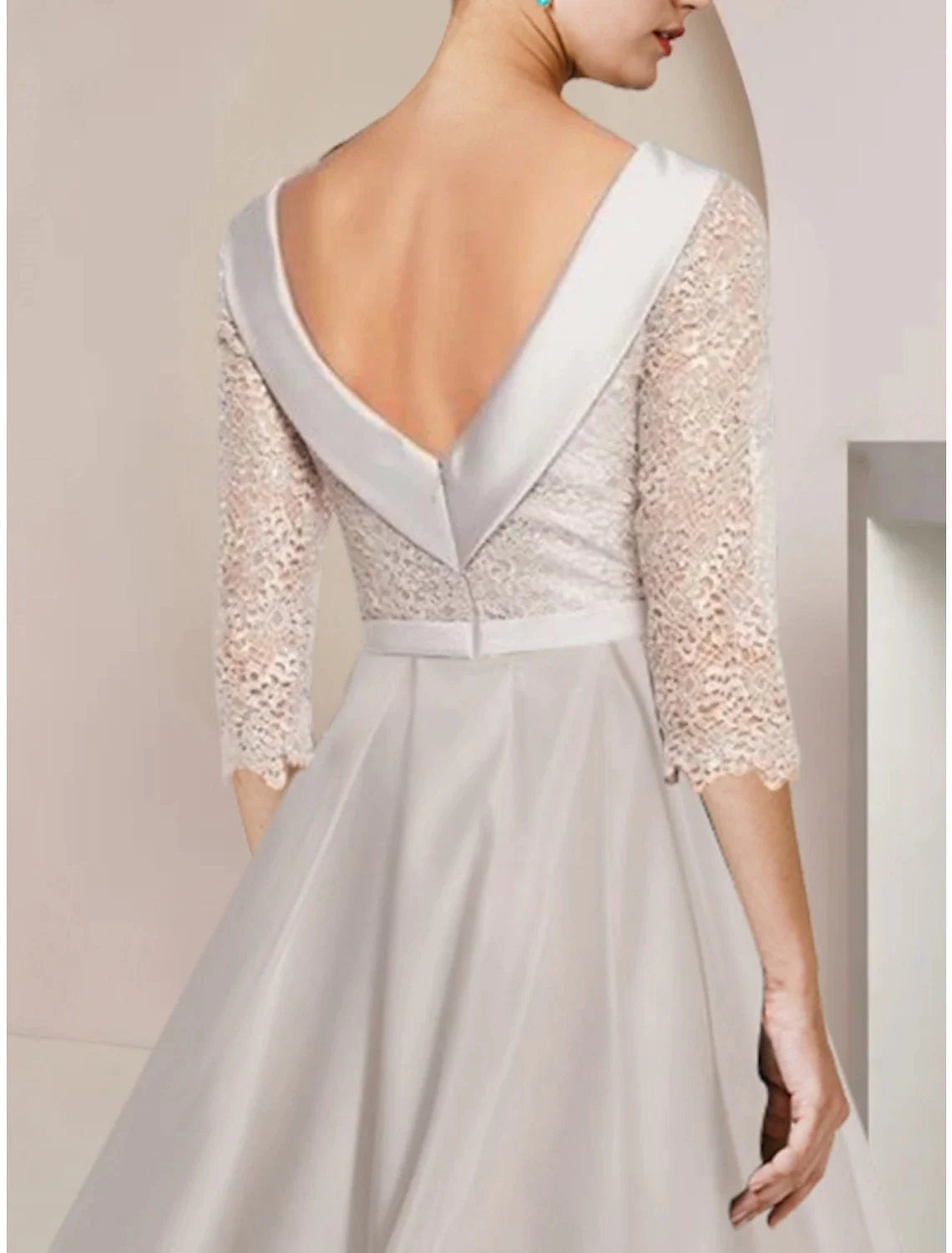 Side view of the satin sheath dress, highlighting delicate ruching detail.