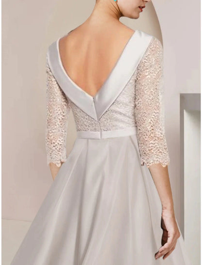 Side view of the satin sheath dress, highlighting delicate ruching detail.