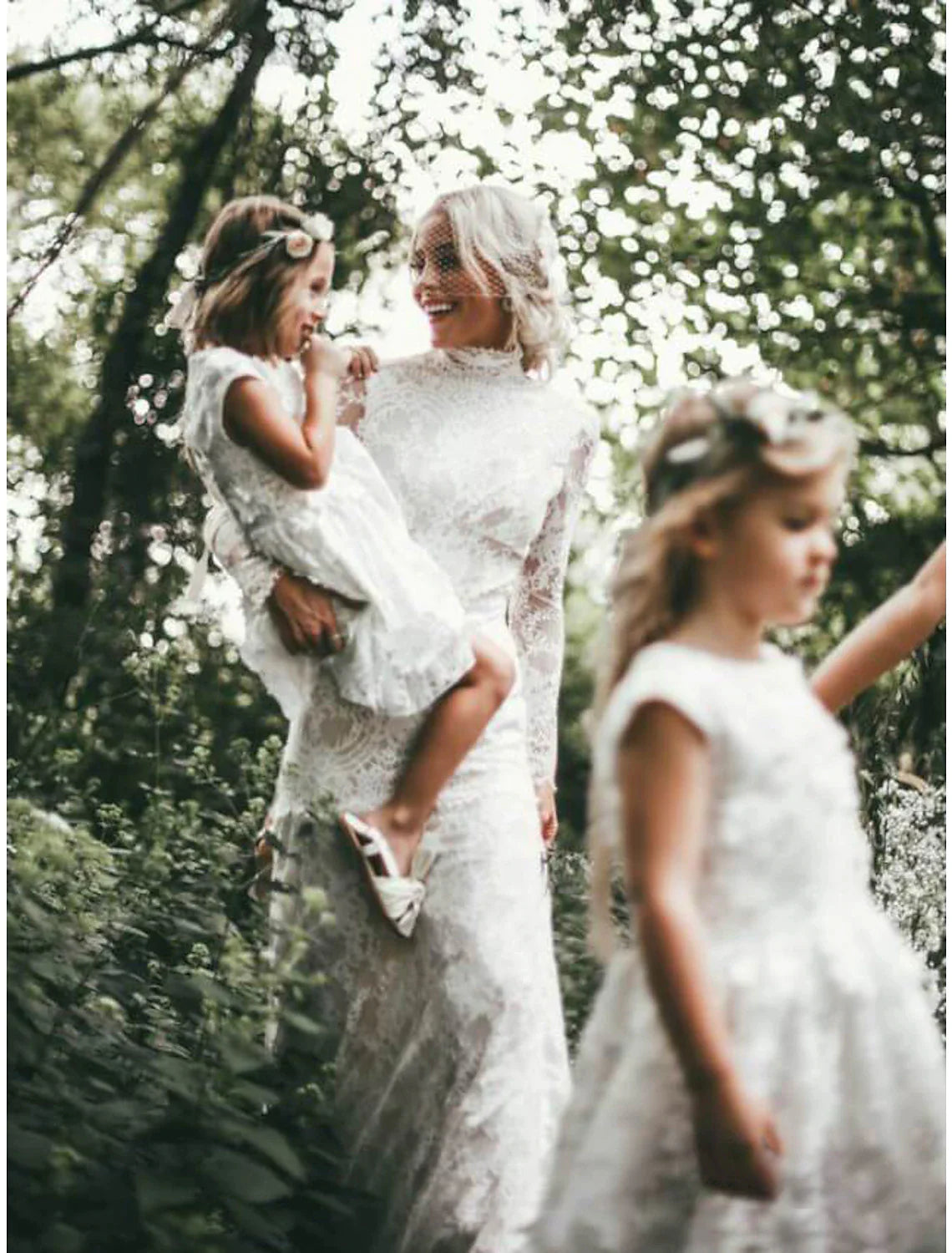 Boho sheath wedding dress with high neck and long sleeves.