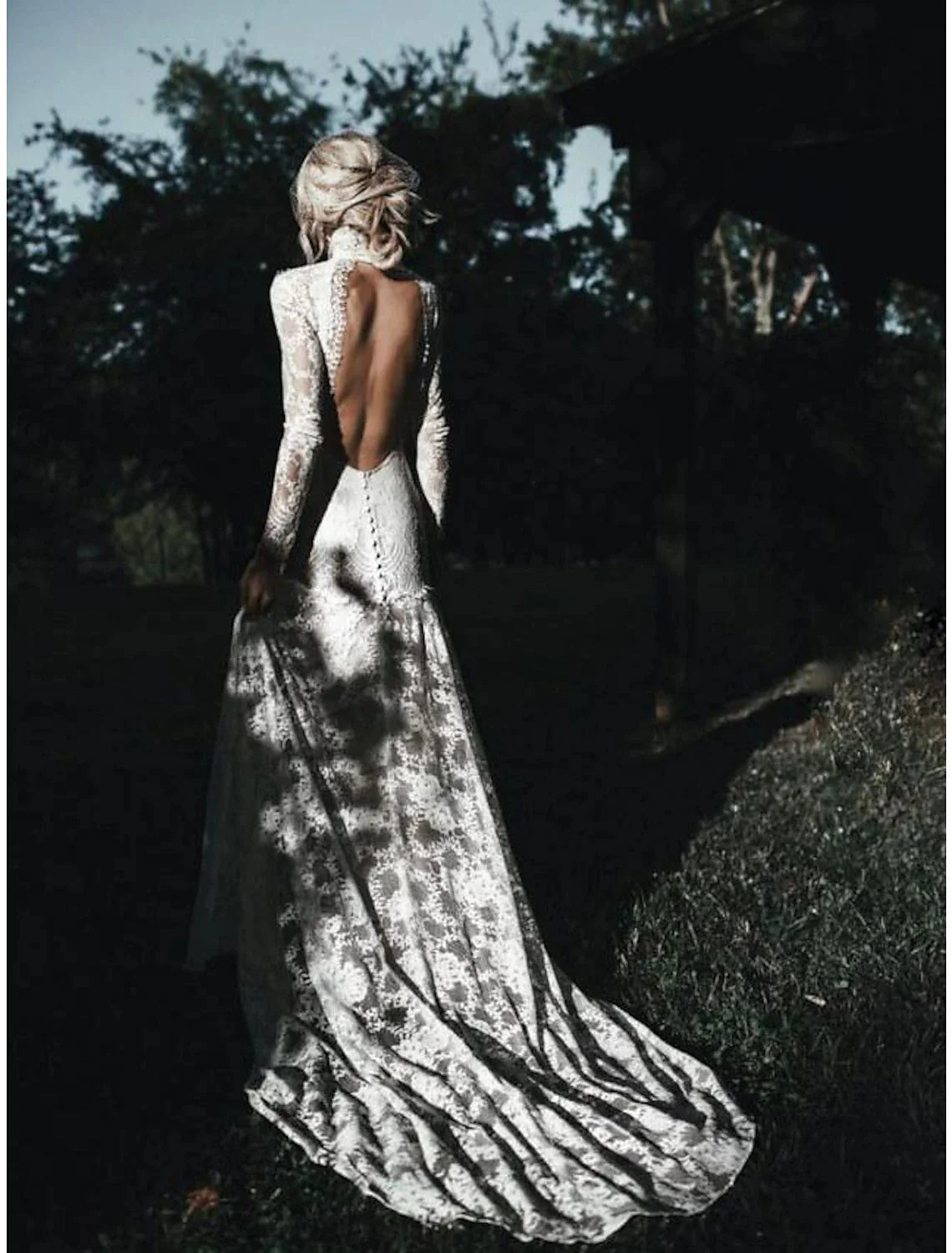 Close-up of the high neck and lace long sleeves on a wedding dress.