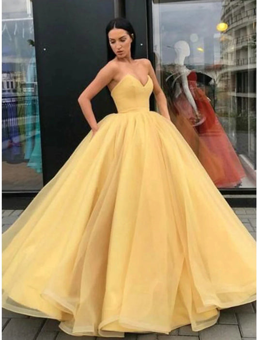 Elegant strapless ball gown with a beautiful back, floor-length tulle skirt, and sleek pleats.