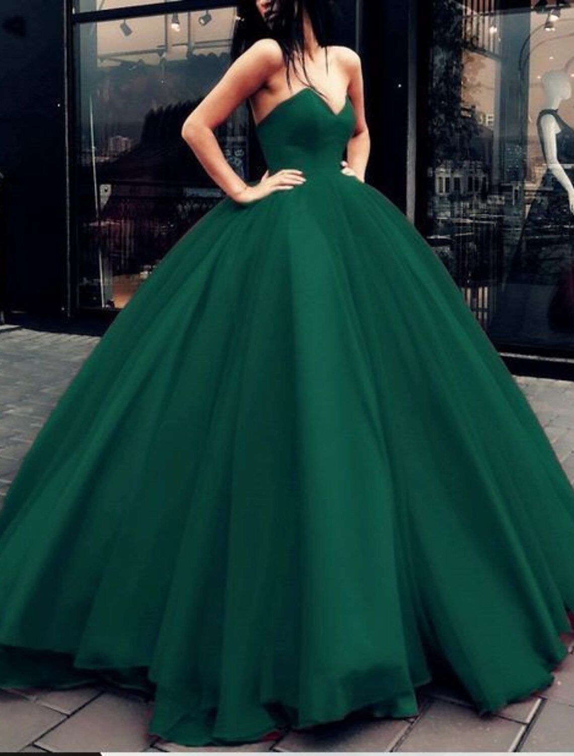Strapless Quinceanera ball gown showing the tiered tulle skirt and pleat details.