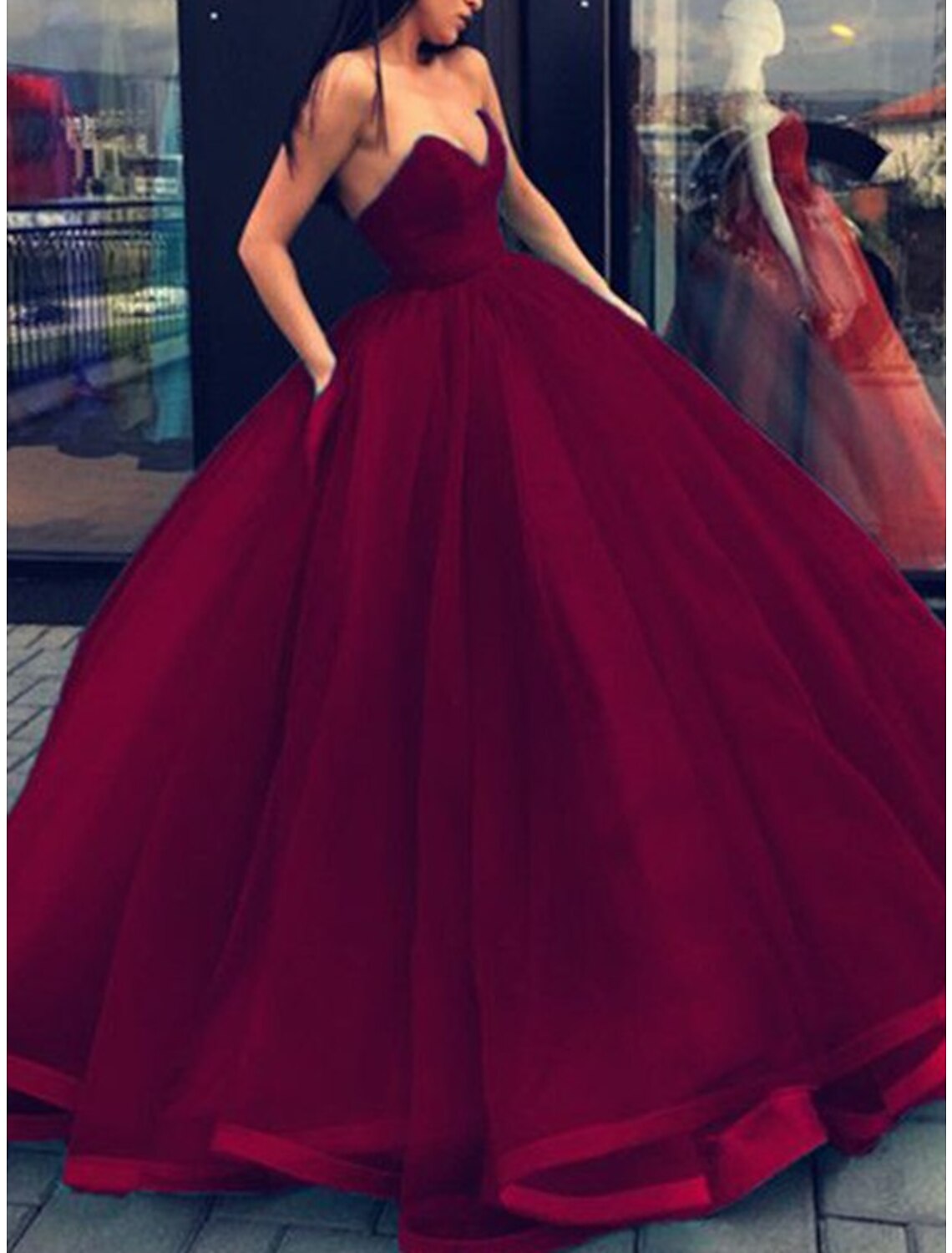 Formal evening dress, a strapless ball gown with a flowing floor-length skirt.