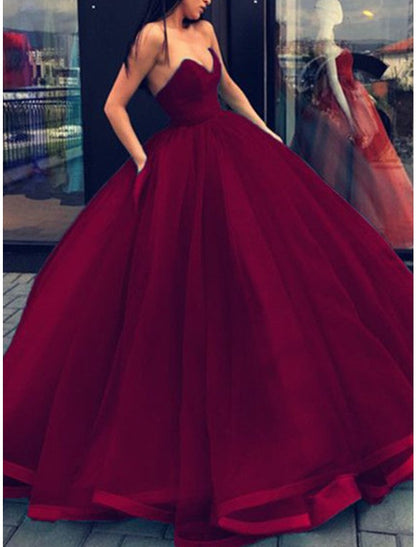 Formal evening dress, a strapless ball gown with a flowing floor-length skirt.