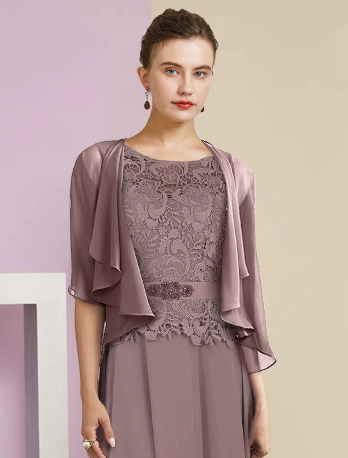 Close-up of lace appliques and crystal brooch on the gown.