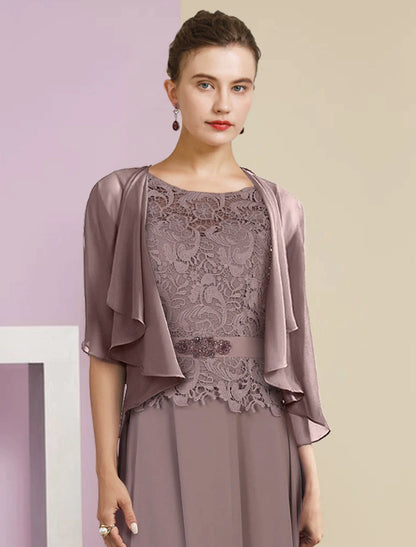 Close-up of lace appliques and crystal brooch on the gown.