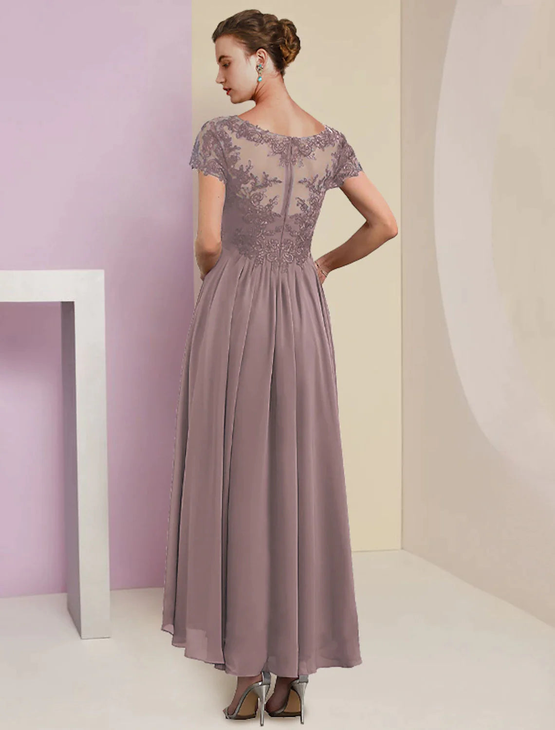Formal tea-length dress featuring lace details and pleats.