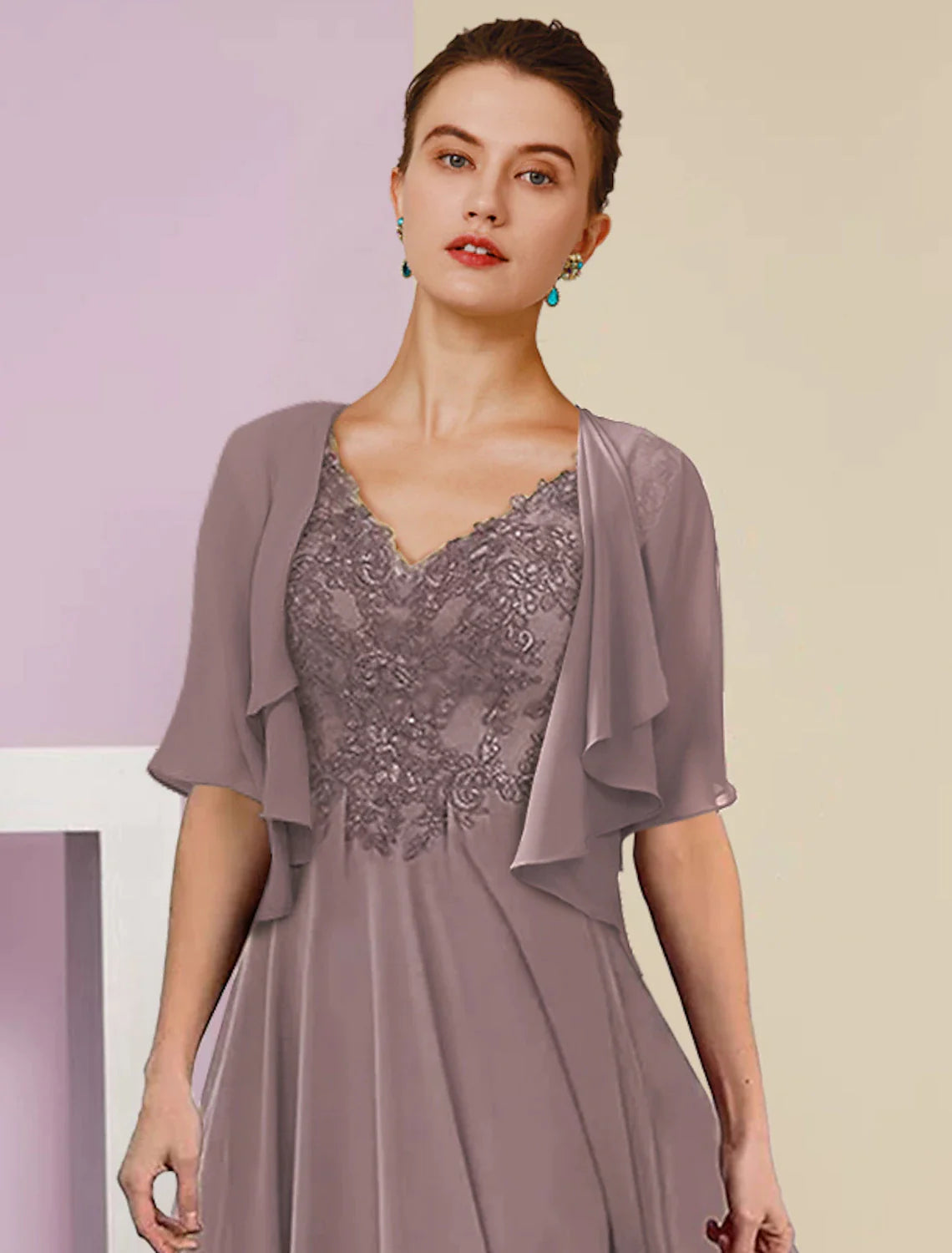 Close-up of the intricate lace and applique details on the dress.
