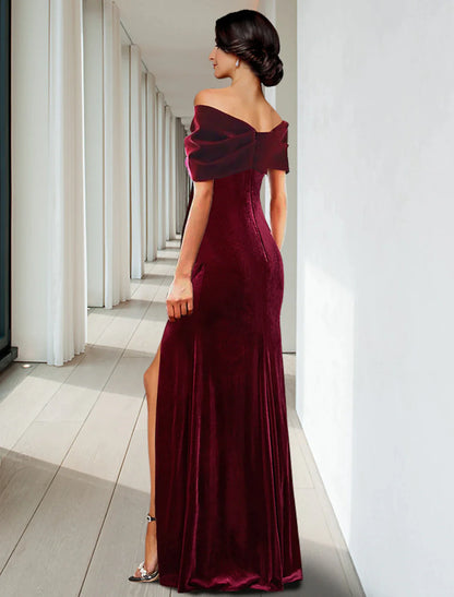 Side view of the dark velvet floor-length gown, highlighting its luxurious texture.