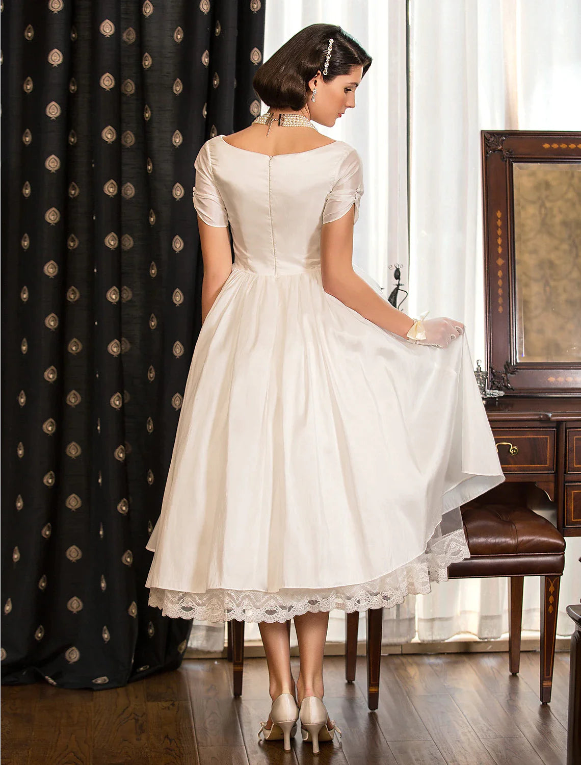 Back view of the A-Line reception dress showing the tea-length hem.