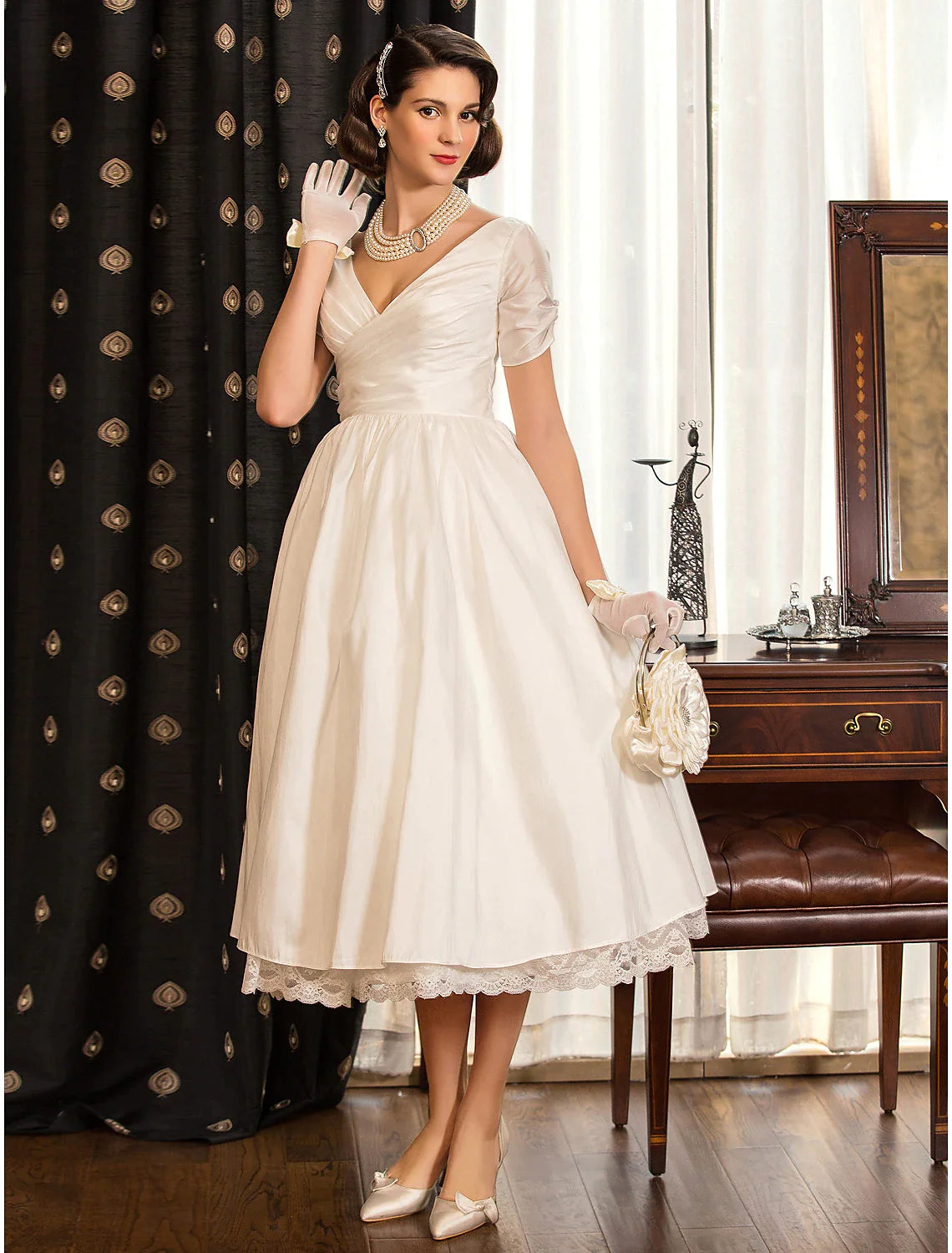 Detail of the lace criss-cross embellishment on the satin wedding dress.