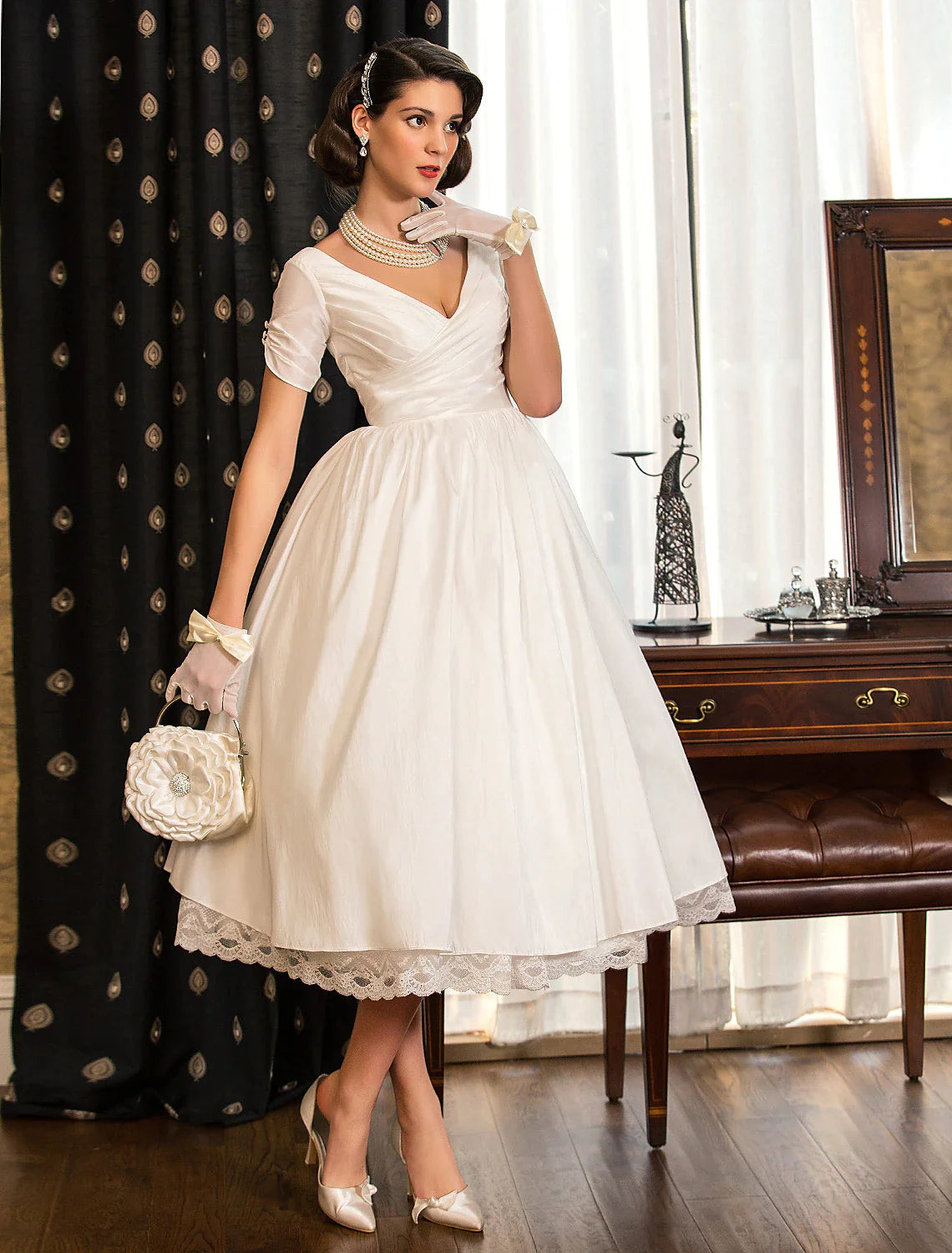 Full length view of the vintage-inspired white bridal gown for summer or fall weddings.