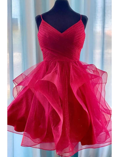 Model wearing a glitter tulle A-line ball gown with spaghetti straps.