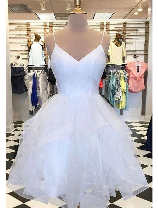 Model posing in a glittering tulle ball gown mini homecoming dress.