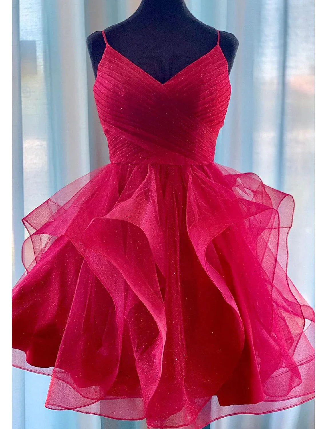 Close-up of the puff-tiered skirt and glittering fabric of the mini homecoming dress.