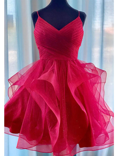 Close-up of the puff-tiered skirt and glittering fabric of the mini homecoming dress.