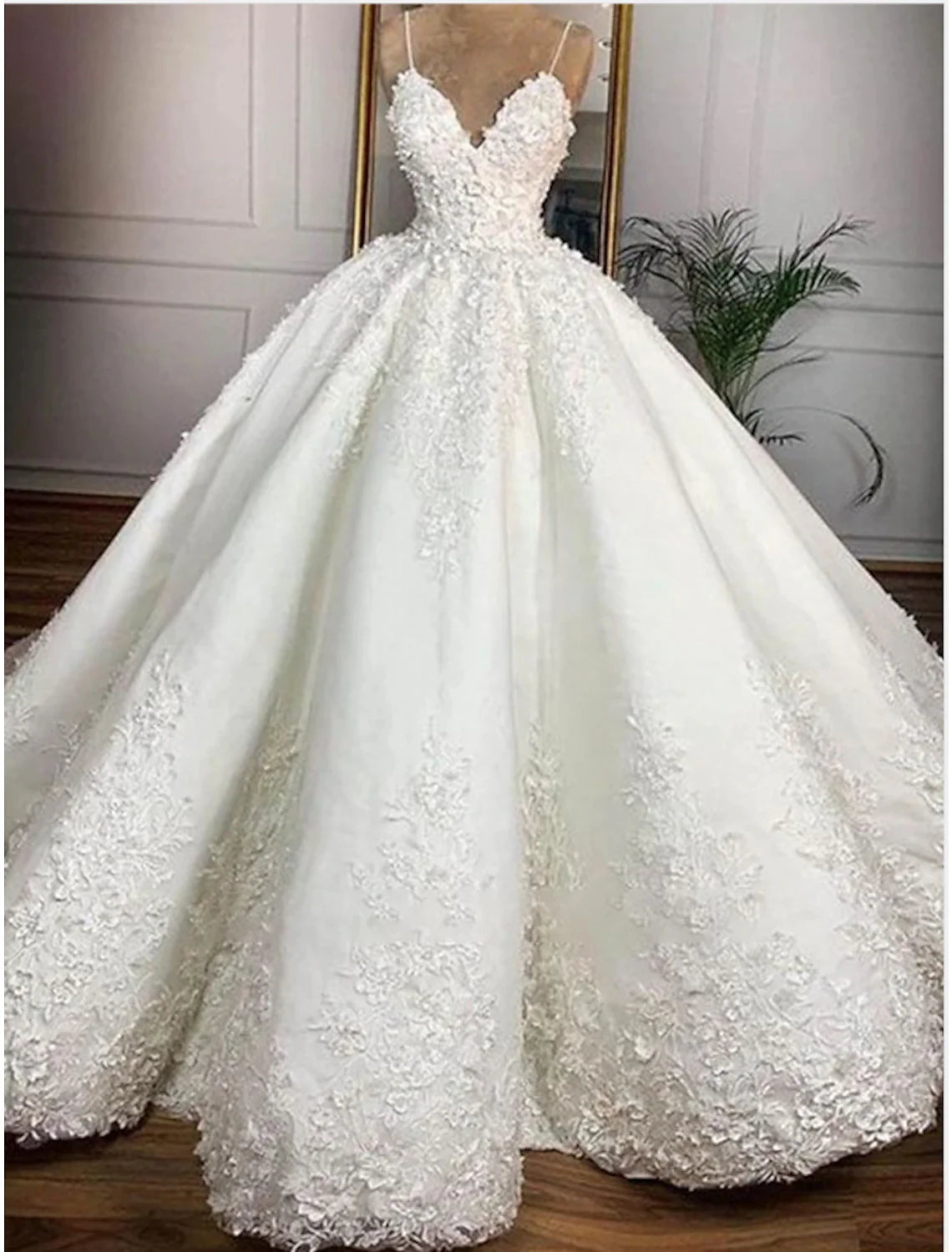 Elegant white ball gown wedding dress with sweetheart neckline, spaghetti straps, and appliques.