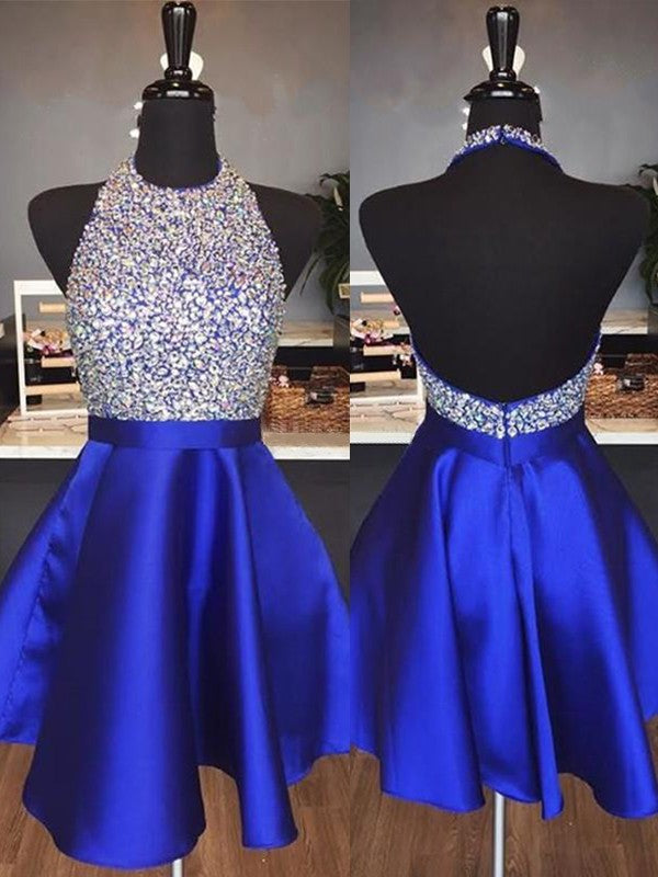 Side view of a short royal blue satin homecoming dress with halter neckline.