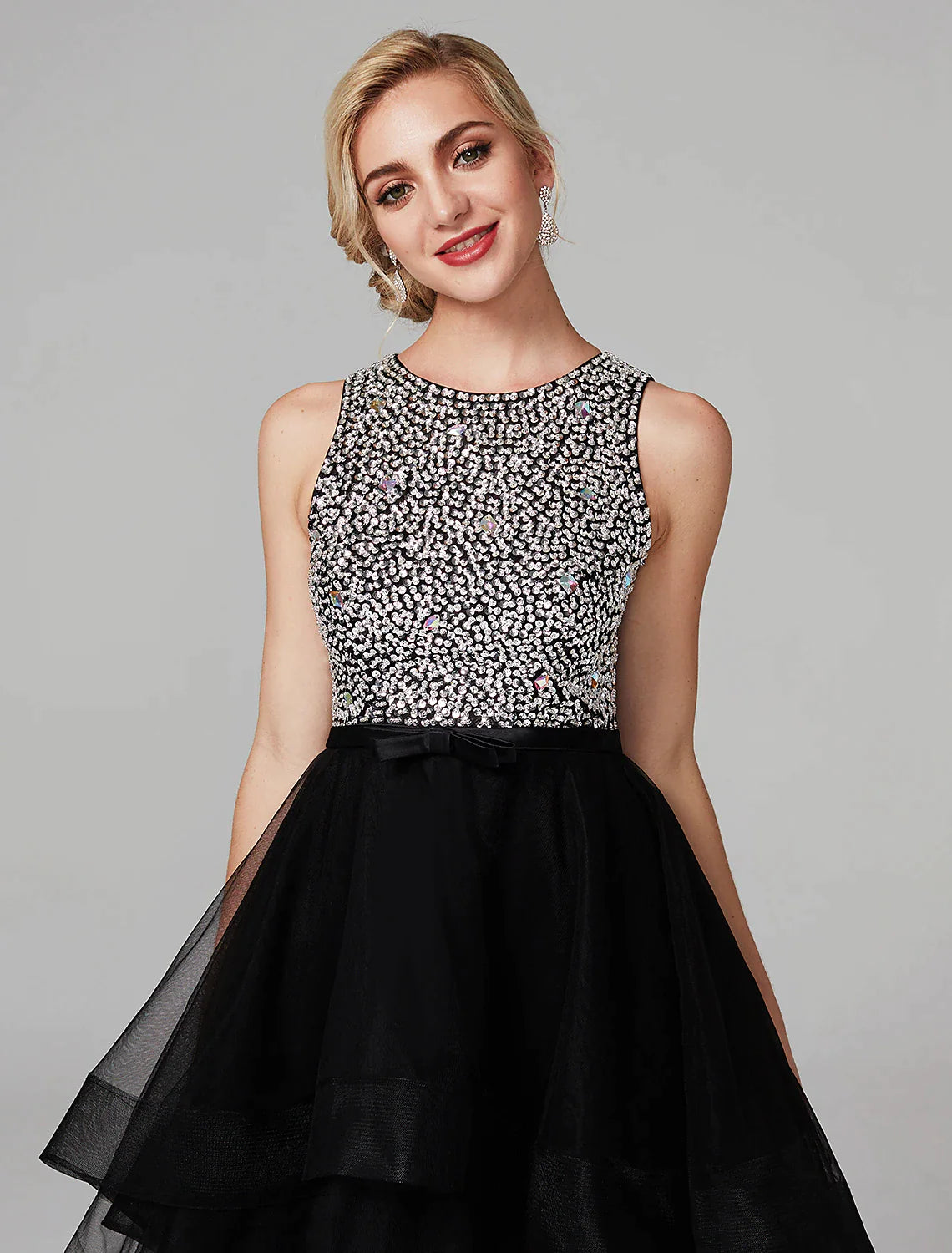 Close-up of the beaded detail and cascading ruffles on the satin dress.