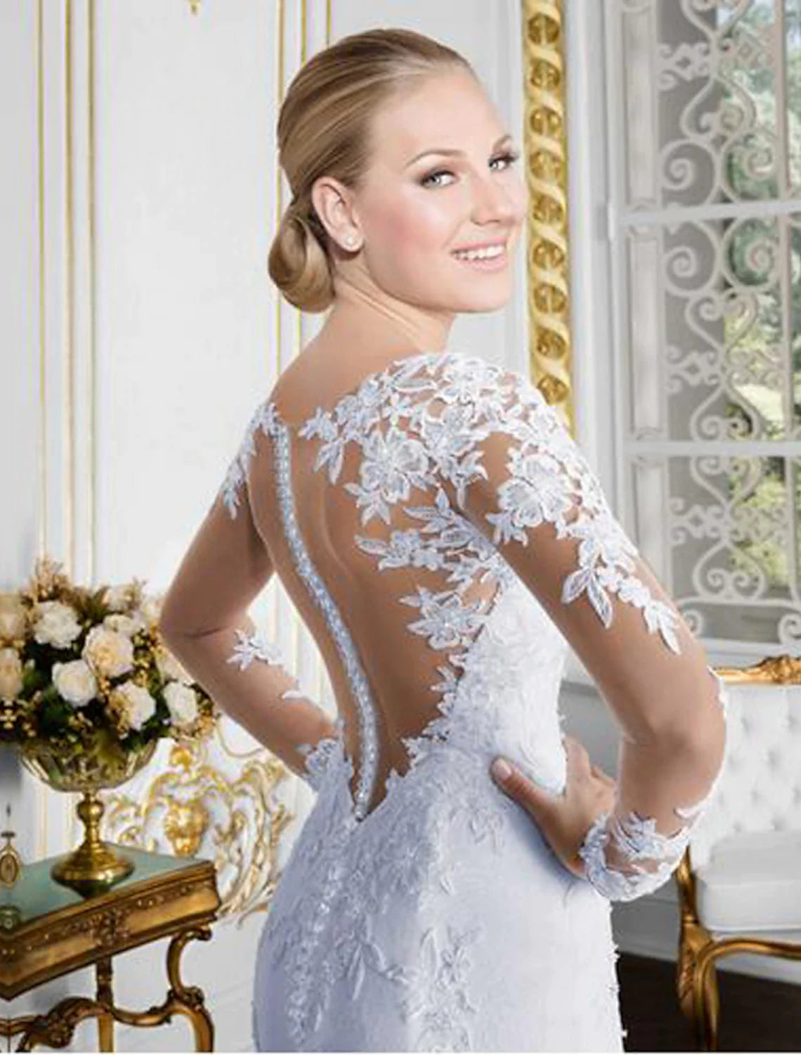 Back view of the mermaid wedding dress, showcasing the open back and chapel train.
