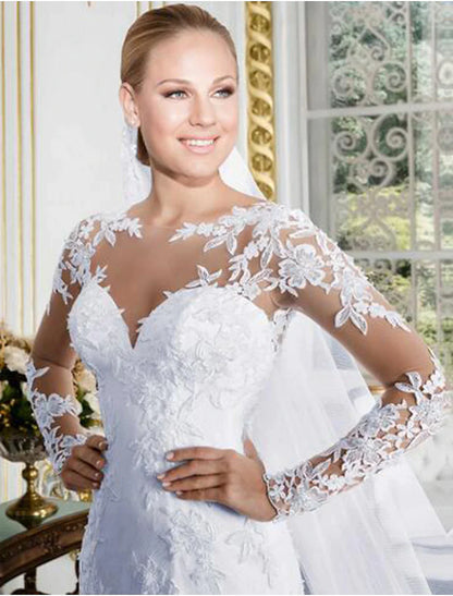 Side profile of the lace mermaid bridal gown, highlighting the elegant silhouette and long sleeves.