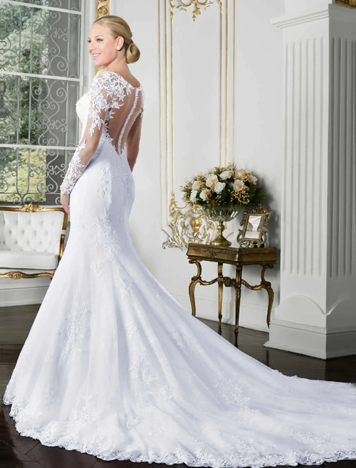 Close-up of the delicate lace appliques and illusion neckline on the wedding dress.