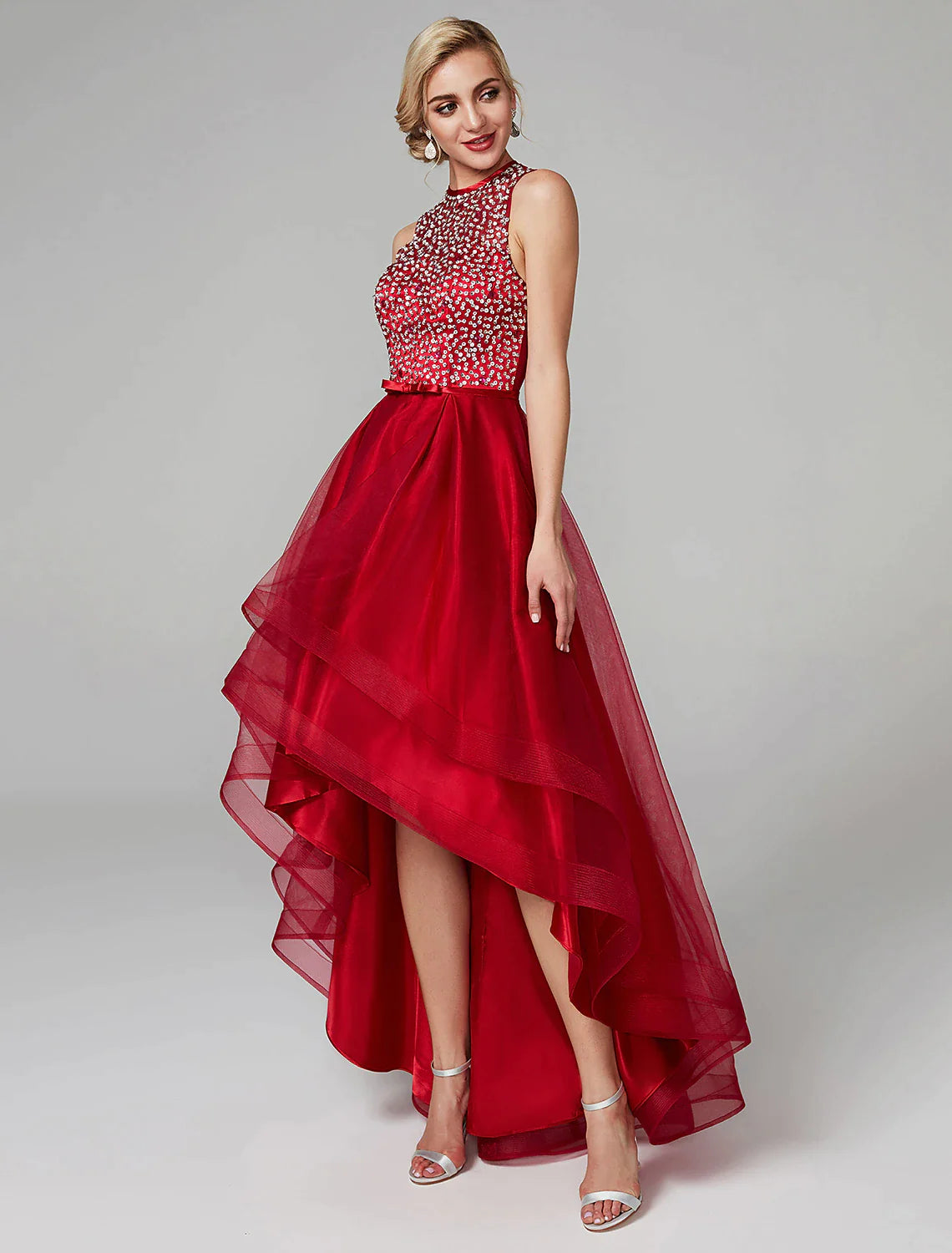 Woman wearing a shimmering A-line sequin satin wedding guest dress.