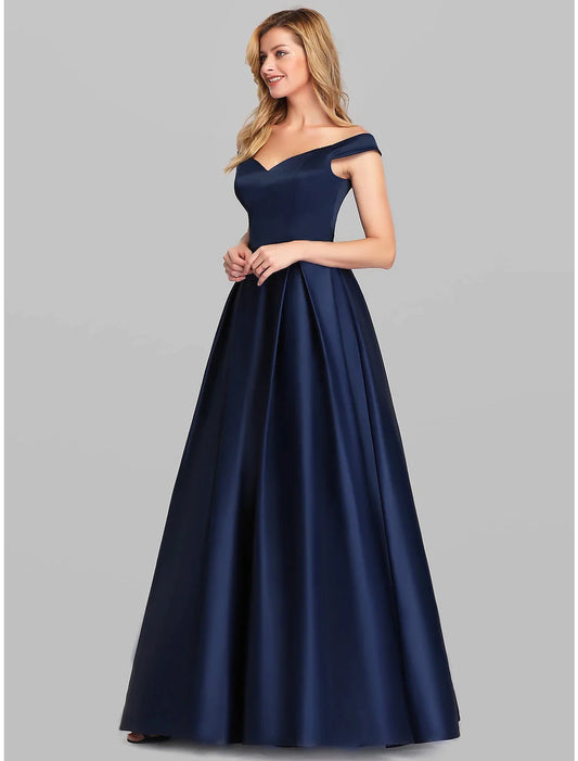 Woman wearing a sophisticated A-Line charmeuse evening gown with a plunging neckline and ruched bodice.