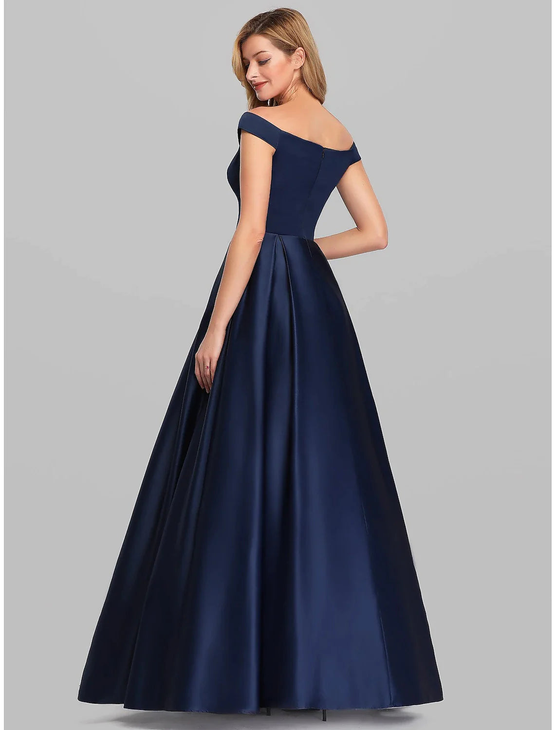 Back view of a woman in a flowing floor-length A-Line evening gown, showcasing its graceful drape.