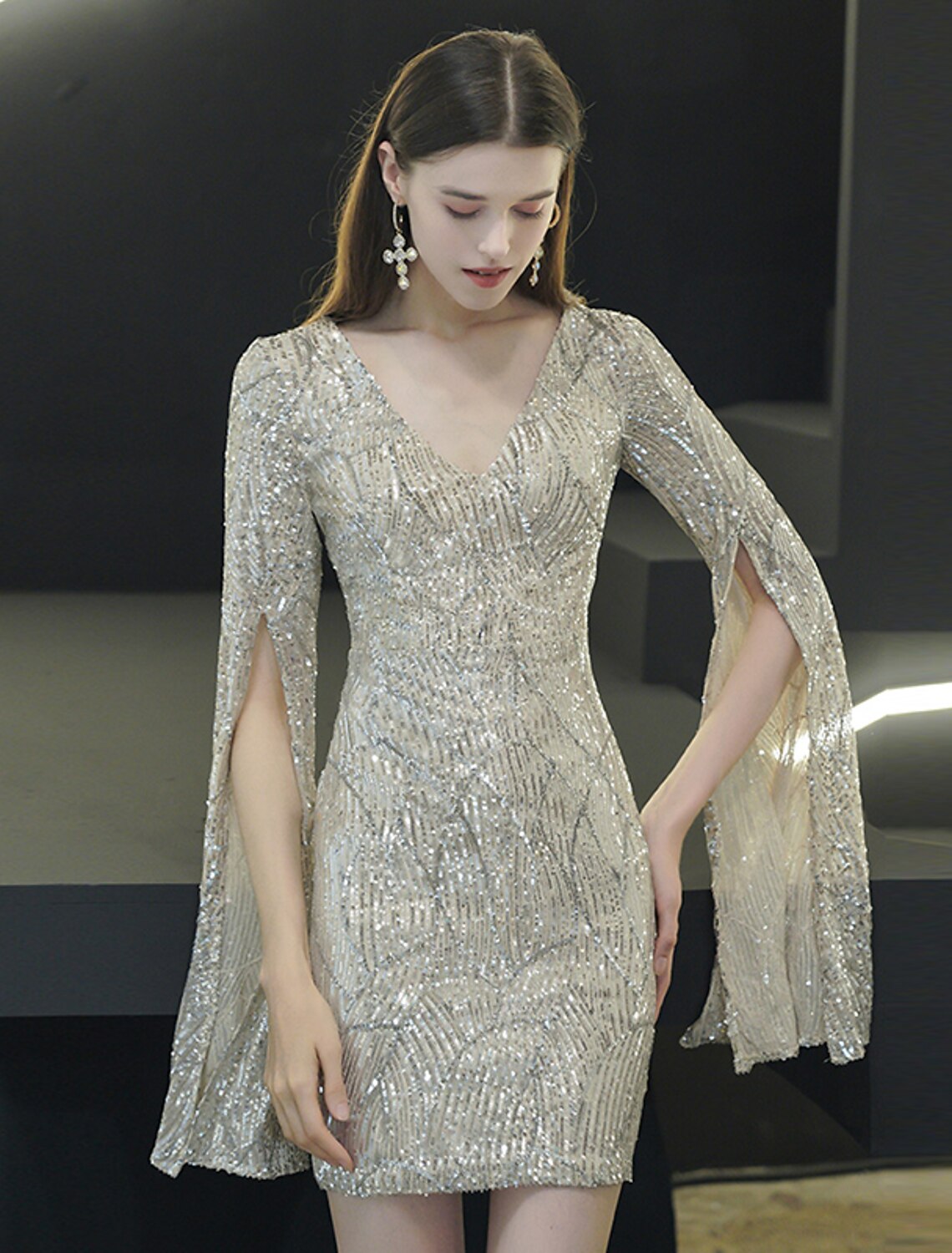 Model showcasing the thigh-high slit on the sequin mini dress.