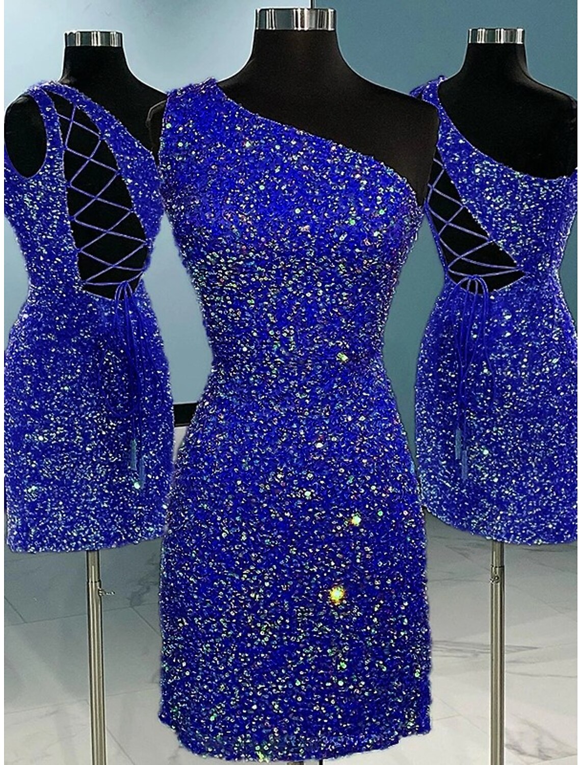 Close-up of a sequined one-shoulder mini dress with glitter straps.
