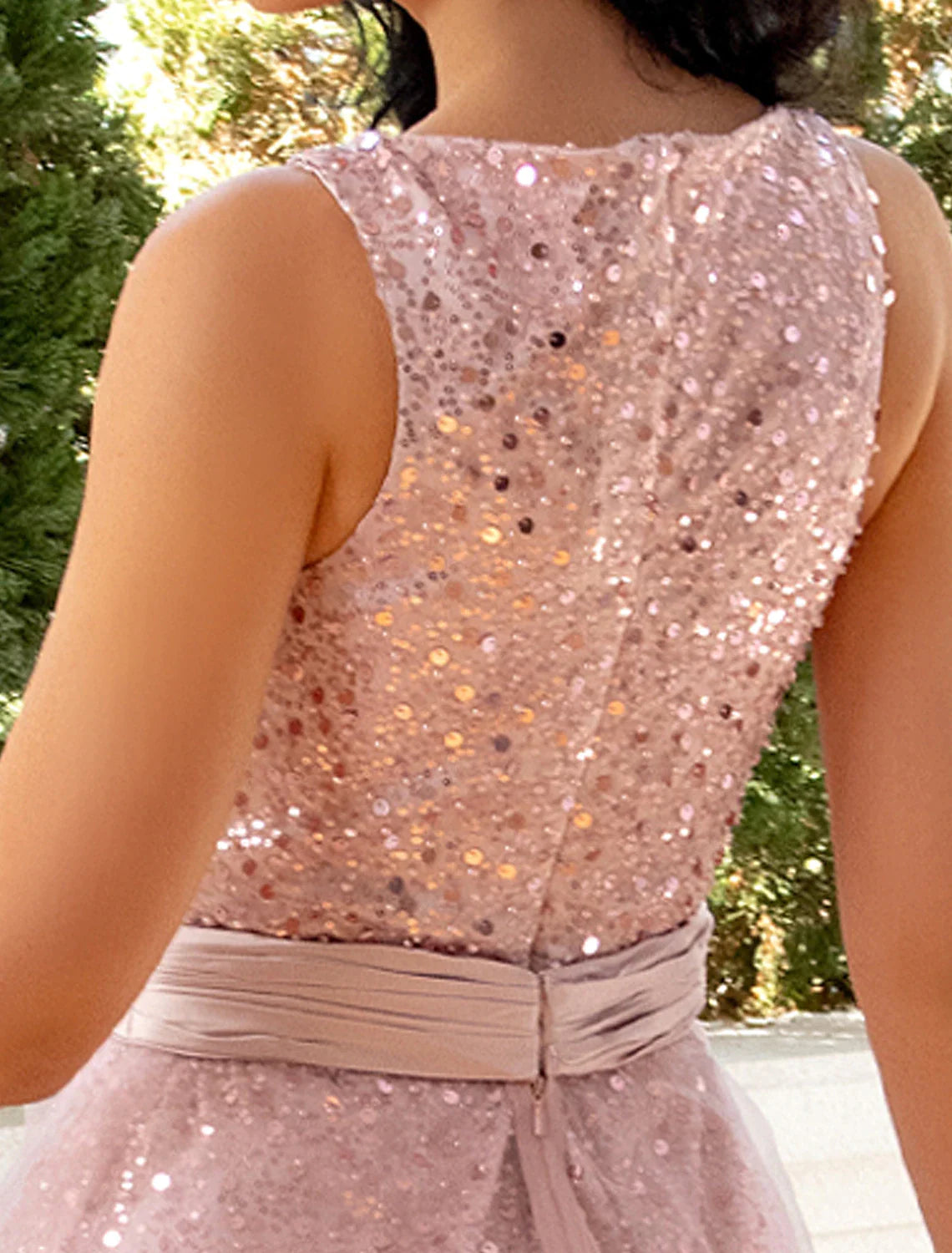 Model in a dynamic pose, showing the flow and sparkle of the tea-length sequin dress.
