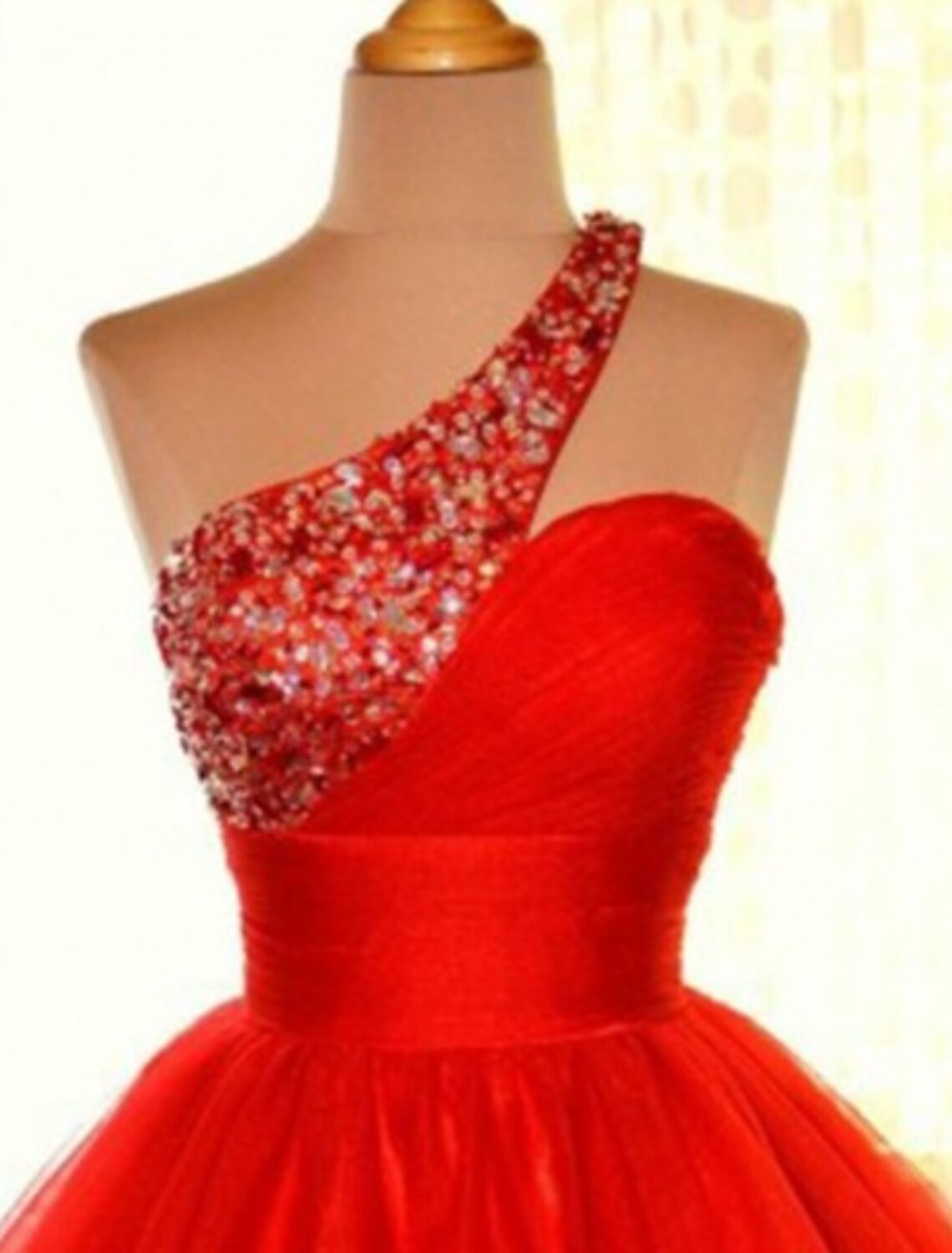 Back view of the A-line one-shoulder sequin tulle dress, showcasing its short length.