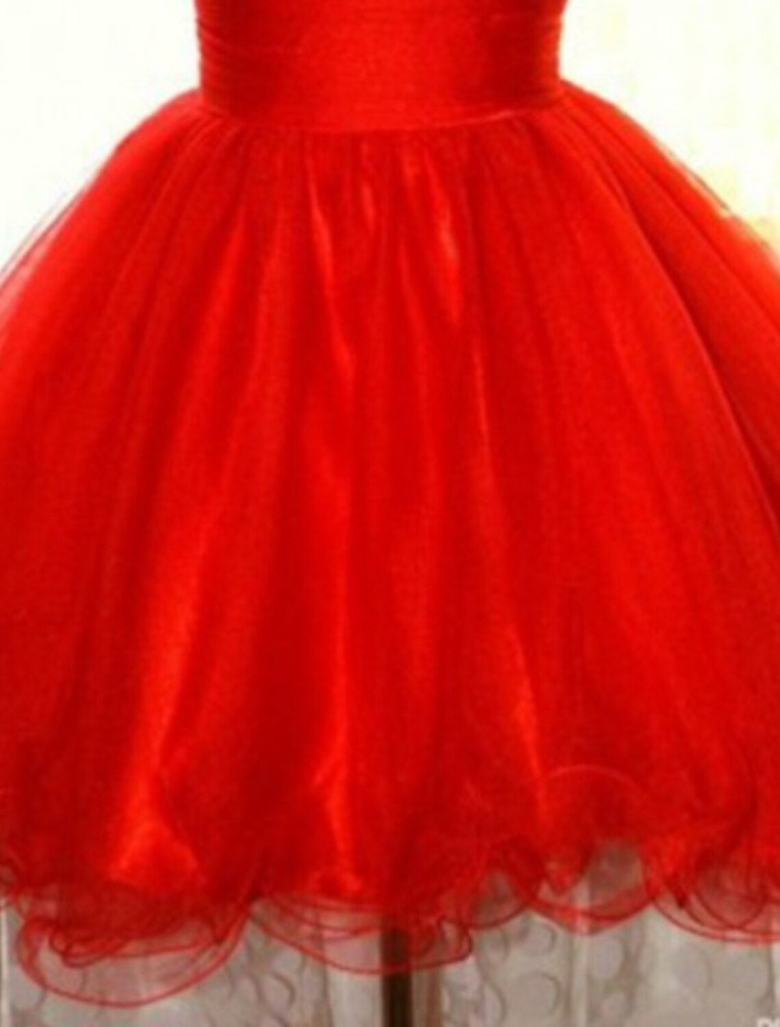 Front view of the sparkling A-line short dress, highlighting the one-shoulder design and sequin details.