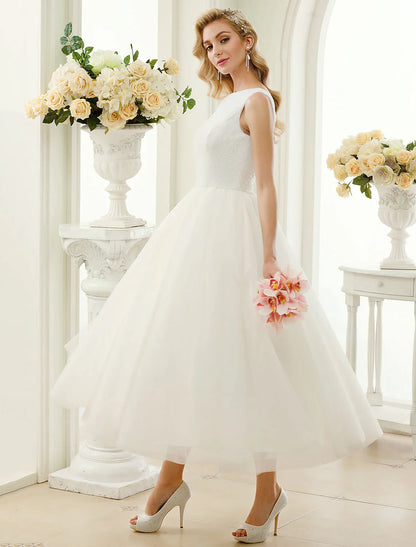 Close-up of the scoop neck and sleeveless design of the white bridal gown.